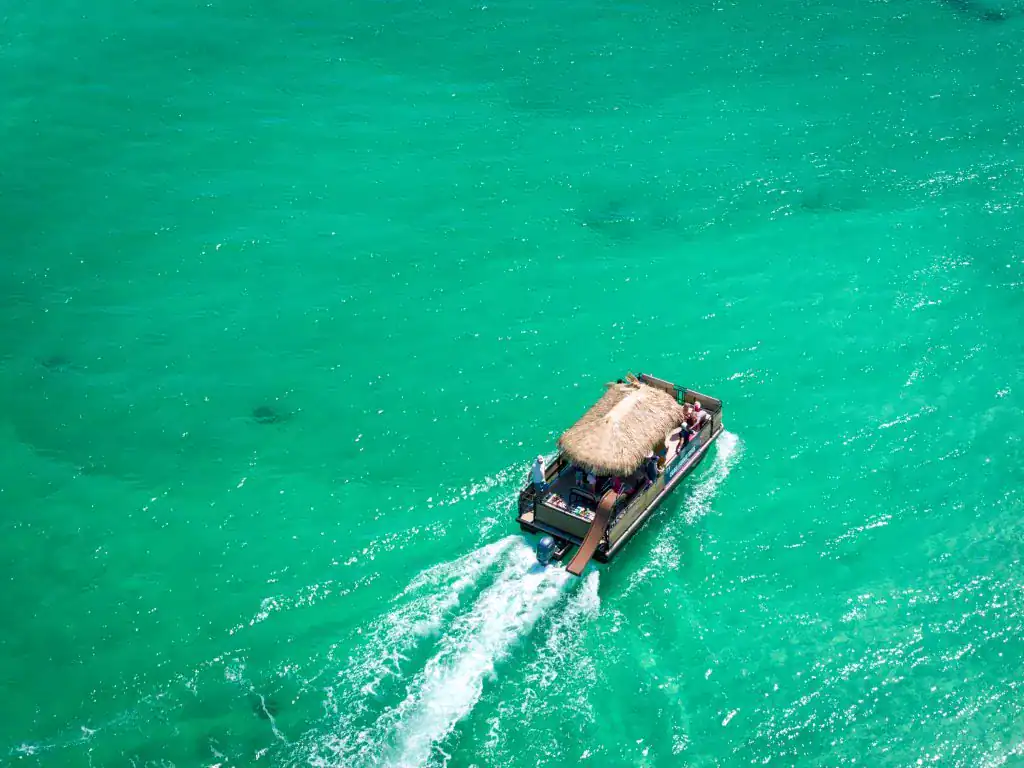 Vessel cruising through clear turquoise waters off Key West on a boat rental.