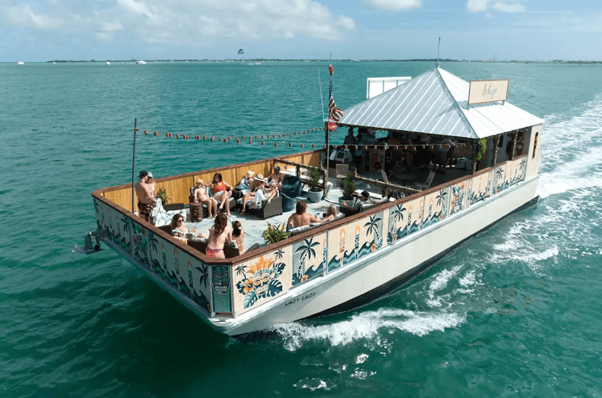 Relaxing Key West boat rental cruise featuring a spacious deck with guests enjoying the sun and ocean breeze. Perfect for sightseeing, parties, and water adventures in Key West.