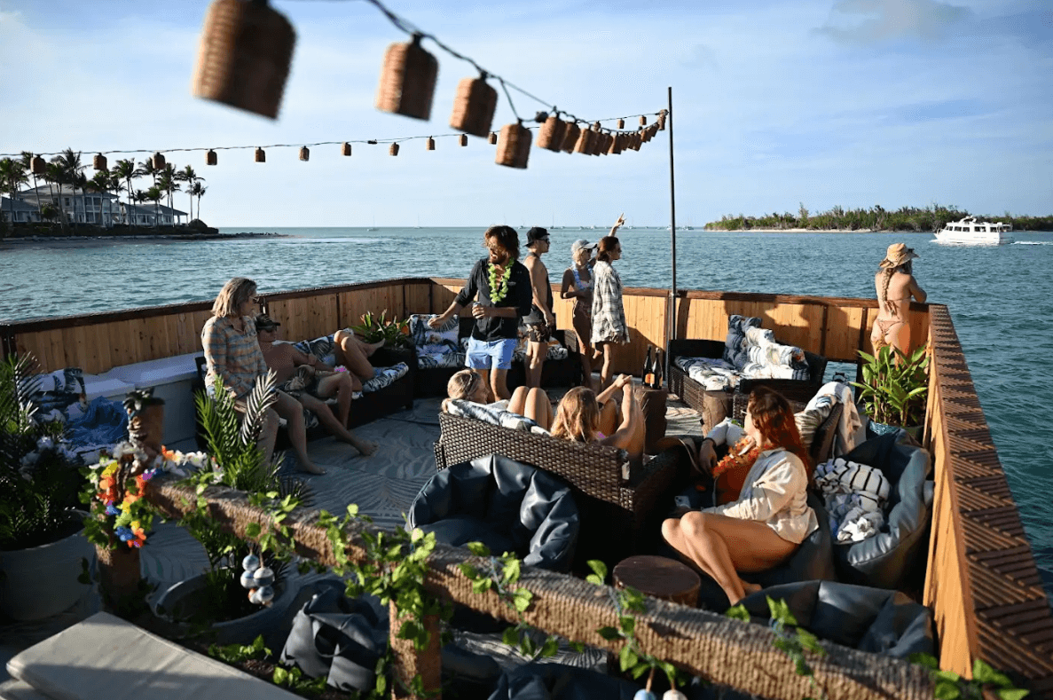 Elegant Key West boat rental cruise deck with guests relaxing and enjoying scenic ocean views, perfect for island adventures and private parties.
